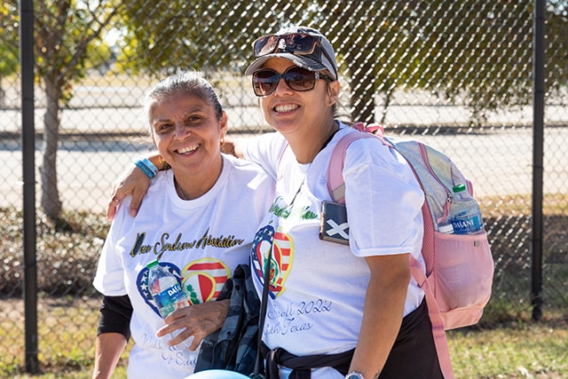 mom and daughter smiling with arms around each other