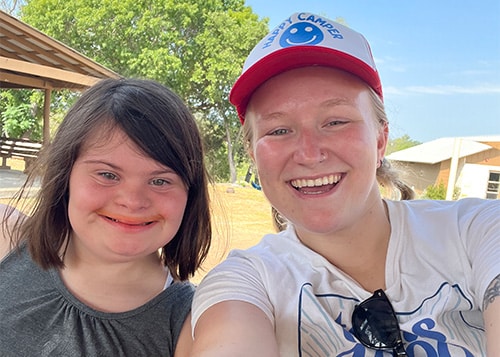 young girl with Down syndrome with her camp counselor